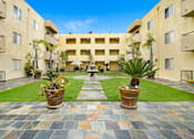 Thumbnail 8 of 11 - a courtyard with a fountain in the middle of an apartment building