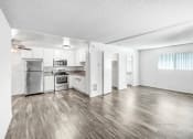 Thumbnail 44 of 66 - the living room and kitchen of an apartment with stainless steel appliances