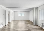Thumbnail 59 of 66 - an empty living room with white walls and a wood floor