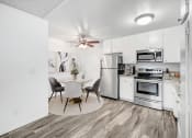 Thumbnail 10 of 66 - a kitchen with white appliances and a dining table