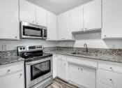 Thumbnail 19 of 66 - a kitchen with white cabinets and stainless steel appliances