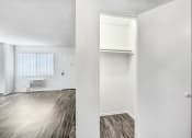 Thumbnail 64 of 66 - an empty living room with white walls and wood flooring