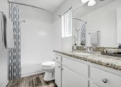 Thumbnail 16 of 66 - a bathroom with a sink and a toilet and a shower