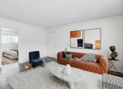 Thumbnail 4 of 66 - a living room with a orange couch and a white table