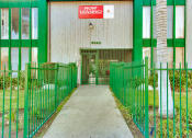 Thumbnail 14 of 17 - a green and white building with a sign that reads now leasing