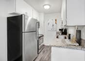 Thumbnail 1 of 66 - a kitchen with stainless steel appliances and granite counter tops