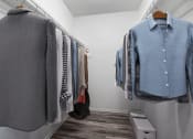 Thumbnail 7 of 66 - a closet with shirts and jackets hanging on the wall