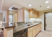 Thumbnail 3 of 20 - a kitchen with granite counter tops and a sink