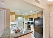 Thumbnail 1 of 20 - a kitchen with stainless steel appliances and granite counter tops