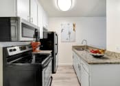Thumbnail 1 of 61 - a kitchen with stainless steel appliances and granite counter tops