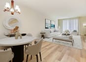 Thumbnail 11 of 20 - a living room and dining room with a table and chairs