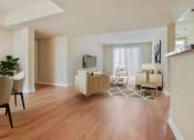 Thumbnail 5 of 20 - a living room and dining room with a hard wood floor