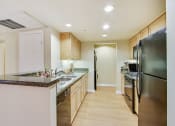 Thumbnail 4 of 20 - a kitchen with stainless steel appliances and granite counter tops