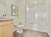 Thumbnail 9 of 20 - a bathroom with a toilet and a shower