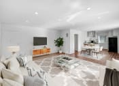 Thumbnail 5 of 57 - a living room with a white couch and a glass table