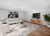 Thumbnail 6 of 57 - a living room with a white couch and a television