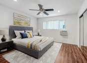 Thumbnail 10 of 57 - a bedroom with a bed and a ceiling fan