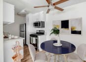 Thumbnail 2 of 64 - an open kitchen and dining room with a blue table and chairs