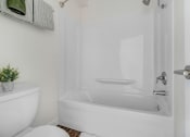 Thumbnail 9 of 64 - a white bathroom with a white toilet and a bath tub