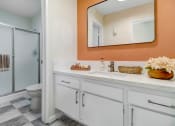 Thumbnail 58 of 64 - a bathroom with a mirror and a toilet and a shower