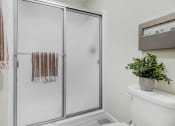 Thumbnail 59 of 64 - a bathroom with a shower and a toilet and a plant