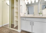 Thumbnail 5 of 61 - a bathroom with a sink and a mirror and a shower