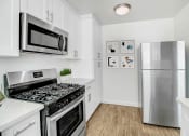 Thumbnail 2 of 52 - a kitchen with stainless steel appliances and a refrigerator