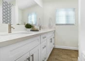 Thumbnail 8 of 52 - a bathroom with white cabinets and a sink and a mirror