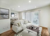 Thumbnail 9 of 102 - a living room with two beds and a couch and a table