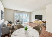 Thumbnail 2 of 102 - a living room with a round table and a couch and a tv