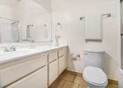 Thumbnail 102 of 102 - a bathroom with a toilet and a sink and a mirror
