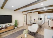 Thumbnail 3 of 17 - a living room with a table and chairs and a television