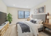 Thumbnail 5 of 17 - a bedroom with a bed and a tv