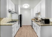 Thumbnail 1 of 30 - an empty kitchen with white cabinets and a counter top