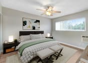 Thumbnail 5 of 30 - a bedroom with a large bed and a ceiling fan