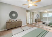 Thumbnail 6 of 30 - a bedroom with a bed and a ceiling fan