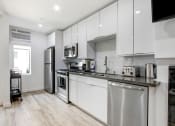 Thumbnail 22 of 29 - Furnished Kitchen with stainless steel appliances, black quartz countertops