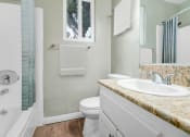 Thumbnail 7 of 30 - a bathroom with a sink toilet and a shower