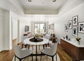 Thumbnail 16 of 88 - a living room with a round table and white chairs