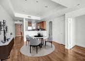 Thumbnail 14 of 88 - a dining room with a table and chairs and a kitchen