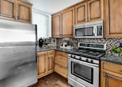 Thumbnail 12 of 88 - a kitchen with stainless steel appliances and wooden cabinets