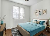 Thumbnail 20 of 88 - a bedroom with a bed and a desk and a window