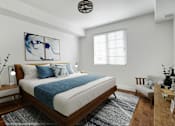 Thumbnail 19 of 88 - a bedroom with a white bed and a blue blanket