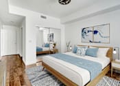 Thumbnail 18 of 88 - a bedroom with a large bed and a mirror