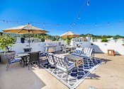 Thumbnail 85 of 88 - a patio with tables and chairs and umbrellas on a roof