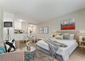 Thumbnail 23 of 76 - Sleeping and living area of a studio unit with a dining and kitchen area on the left