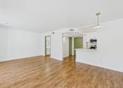 Thumbnail 50 of 60 - A room with wooden floors and white walls.