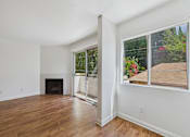 Thumbnail 53 of 60 - A room with a fireplace and a sliding glass door.