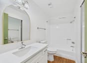 Thumbnail 54 of 60 - A bathroom with a sink, toilet, and bathtub.