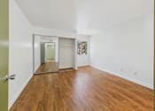 Thumbnail 30 of 60 - A room with wooden floors and a white ceiling.